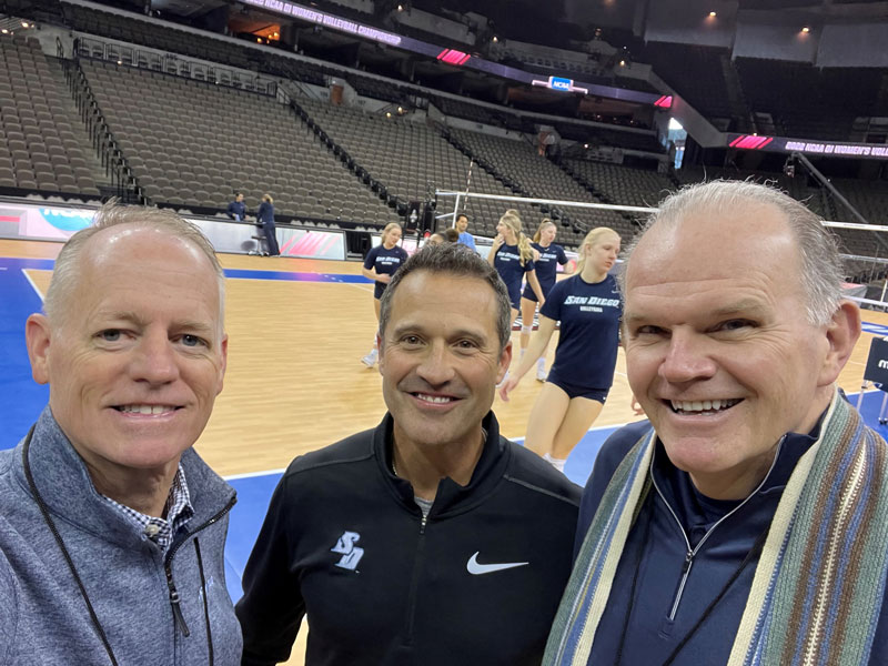 Tom standing between Jim Harris and Bill McGillis on volleyball court