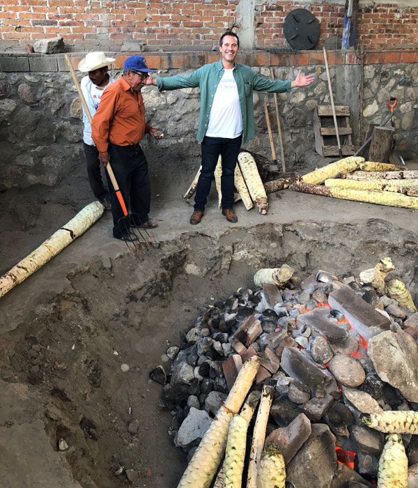 Tom in Oaxaca near an earthen oven roasting agave